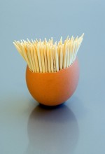 Toothpicks in eggshell on grey blue background
